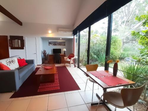 a living room with a couch and a table at Sky Island Studios in Mount Tamborine