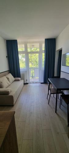 a living room with a couch and a table at Apartamenty Neptun in Świnoujście