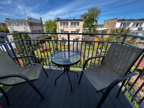 a patio with two chairs and a table on a balcony at Villa Mors in Mielno