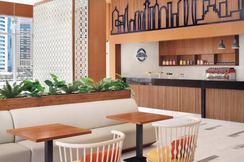 a restaurant with two tables and two chairs at Delta Hotels by Marriott City Center Doha in Doha