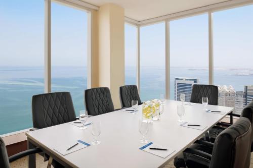 a conference room with a table with chairs and windows at Delta Hotels by Marriott City Center Doha in Doha