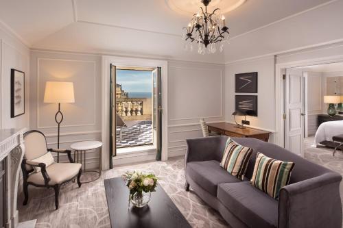 a living room with a couch and a bed at Hotel Maria Cristina, a Luxury Collection Hotel, San Sebastian in Donostia-San Sebastián