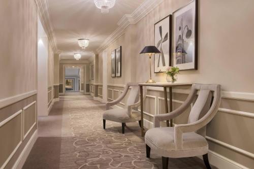 a corridor with a table and chairs in a hallway at Hotel Maria Cristina, a Luxury Collection Hotel, San Sebastian in Donostia-San Sebastián