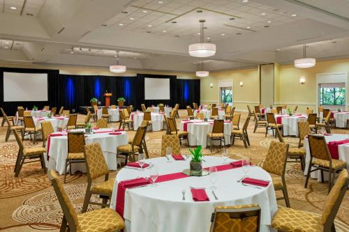 a banquet hall with white tables and chairs at Sheraton Harrisburg Hershey Hotel in Harrisburg