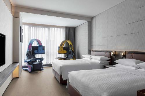 a hotel room with two beds and a tv at Four Points by Sheraton Chengdu Tianfu New Area in Chengdu