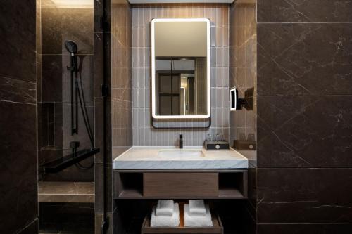 y baño con lavabo y espejo. en Four Points by Sheraton Chengdu Tianfu New Area, en Chengdú