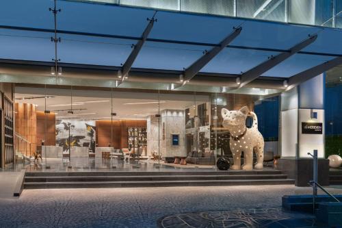 a museum with a statue of a cow on display at Le Meridien Bangkok in Bangkok