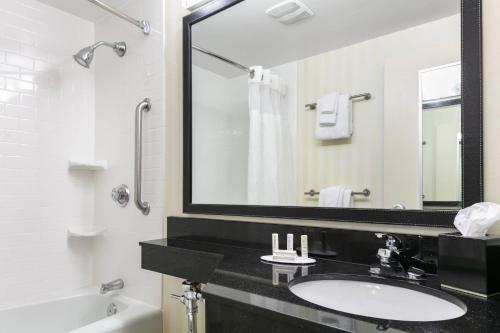 a bathroom with a sink and a large mirror at Chester Inn & Suites in Sharonville