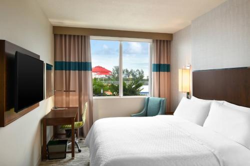 a hotel room with a bed and a window at Four Points by Sheraton Coral Gables in Miami