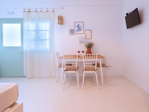 a dining room with a table and chairs at La Vista TINOS in Agios Ioannis Tinos