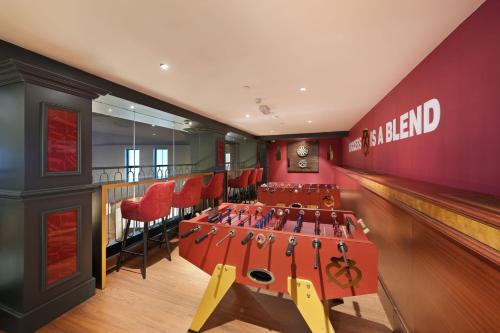 a bowling alley with red stools and a bowling lane at Le Meridien Abu Dhabi Resort in Abu Dhabi