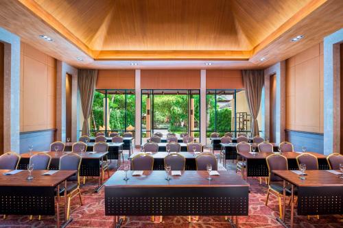 a conference room with tables and chairs and windows at Sheraton Hua Hin Pranburi Villas in Pran Buri