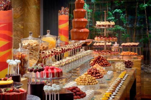 a buffet with many different desserts and cakes at JW Marriott Marquis Hotel Dubai in Dubai