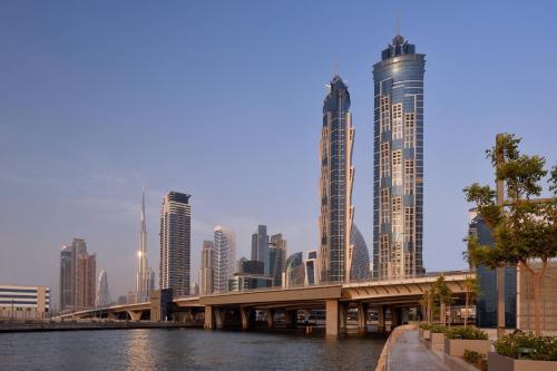 a bridge over a river with tall buildings at JW Marriott Marquis Hotel Dubai in Dubai