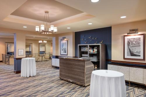 a hotel lobby with a bar and tables at Sheraton Erie Bayfront Hotel in Erie
