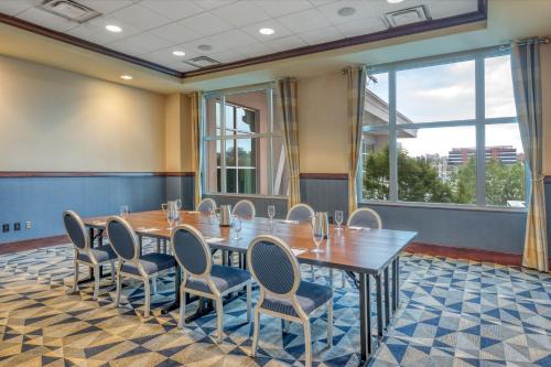 a conference room with a table and chairs and a large window at Sheraton Erie Bayfront Hotel in Erie