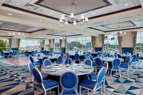 a conference room with long tables and blue chairs at Sheraton Erie Bayfront Hotel in Erie