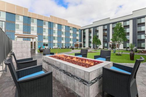 a courtyard with chairs and a fountain in front of a building at Four Points by Sheraton Amarillo Central in Amarillo