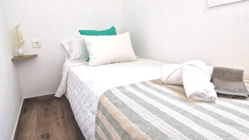 a small bedroom with two beds and a pillow at Vistas mar y montaña LasNegras in Las Negras