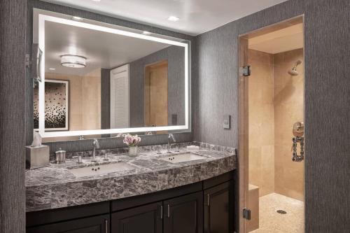 a bathroom with two sinks and a large mirror at The Ritz-Carlton Atlanta in Atlanta