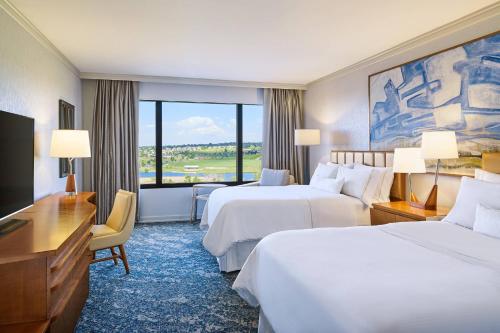 a hotel room with two beds and a large window at The Westin Westminster in Westminster