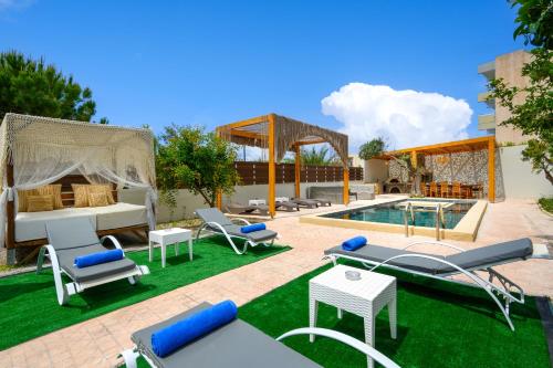 an outdoor patio with a bed and a pool and grass at Afantou Golf Luxury Villa in Afantou