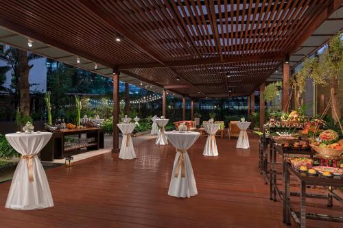 a banquet hall with tables and chairs and a buffet at Marriott Executive Apartments Sukhumvit Park, Bangkok in Bangkok