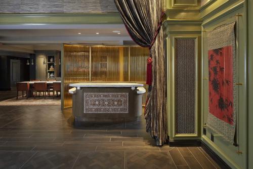 a lobby with a table and a dining room at The Burgess Hotel, Atlanta, a Tribute Portfolio Hotel in Atlanta