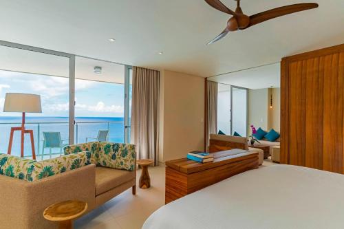 a hotel room with a bed and a view of the ocean at The Westin Cozumel in Cozumel