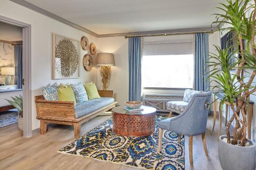 a living room with a couch and a chair at The Burgess Hotel, Atlanta, a Tribute Portfolio Hotel in Atlanta