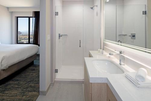 SpringHill Suites by Marriott Valencia في فالنسيا: حمام مع حوض ودش وسرير