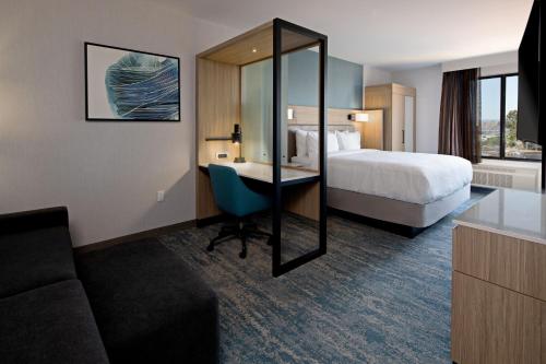a hotel room with a bed and a desk at SpringHill Suites by Marriott Valencia in Valencia
