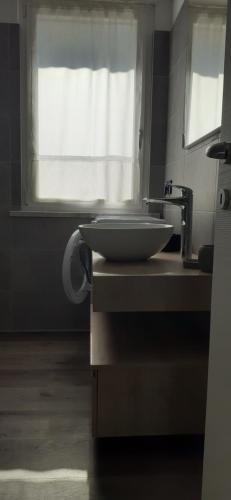 un bagno con lavandino e finestra di APPARTAMENTO LECCINO a Malcesine