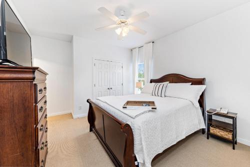 a bedroom with a bed and a ceiling fan at Beach House steps to pool, Beach Access in Gulf Shores