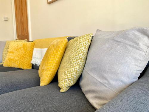a group of pillows sitting on top of a couch at 8 Margaret Road, Whitley Bay in Whitley Bay
