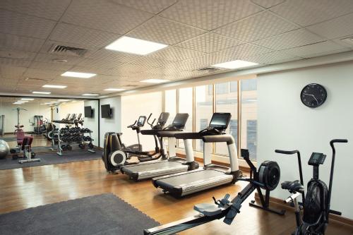 a gym with treadmills and elliptical machines at Four Points by Sheraton Production City, Dubai in Dubai