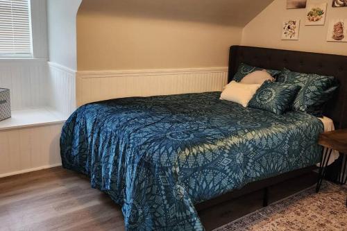 a bedroom with a bed with a blue blanket and pillows at Beautiful 4 bedroom in Cleveland in Euclid