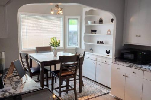 a kitchen and dining room with a table and chairs at Beautiful 4 bedroom in Cleveland in Euclid