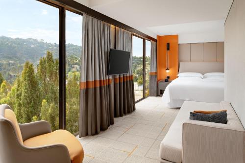 a hotel room with a bed and a large window at Sheraton Universal in Los Angeles