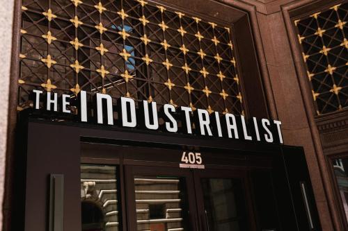 a sign on the front of a restaurant at The Industrialist Hotel, Pittsburgh, Autograph Collection in Pittsburgh