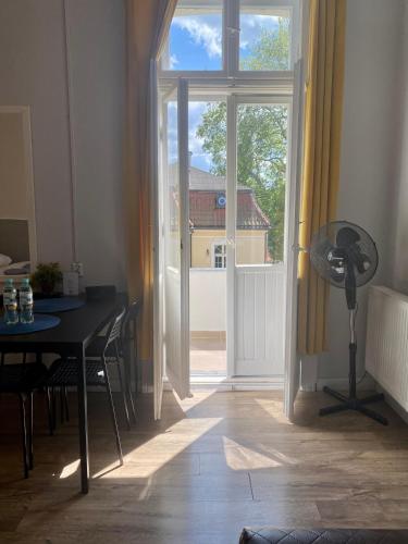 a room with a table and a glass door with a window at Hacienda in Sopot
