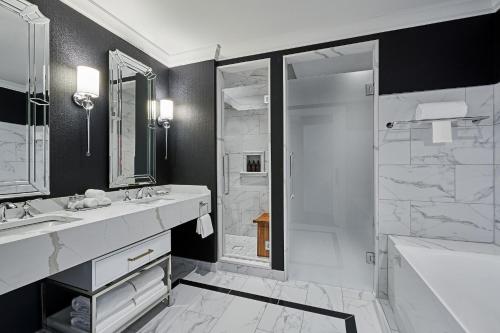 a bathroom with a tub and a sink and a shower at The LaSalle Chicago, Autograph Collection in Chicago