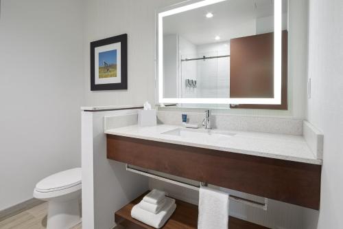 a bathroom with a sink and a toilet at Four Points by Sheraton Sherwood Park in Sherwood Park