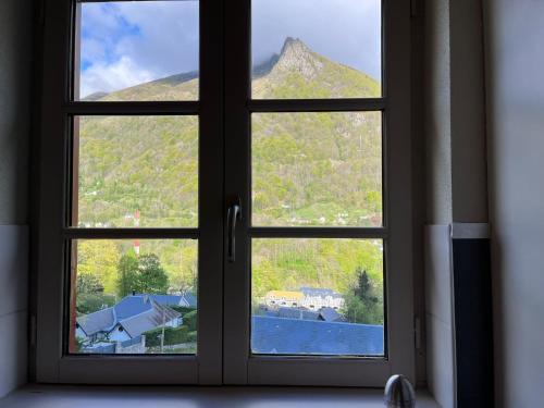 a window with a view of a mountain at Charmant T2 bis in Cauterets