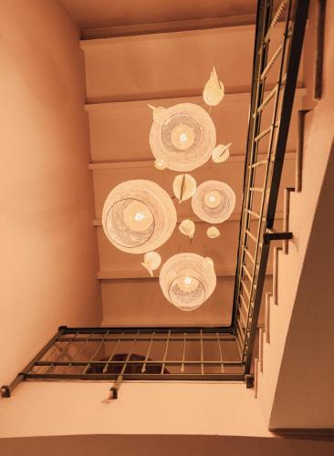a bunch of plates hanging from a rack in a kitchen at Sella&Mosca Casa Villamarina in Alghero