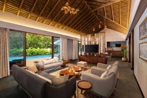 a living room with couches and a tv at Sheraton Grand Chennai Resort & Spa in Mahabalipuram