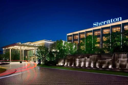 a large building with a sign on it at night at Sheraton Shanghai Chongming Hotel in Chongming