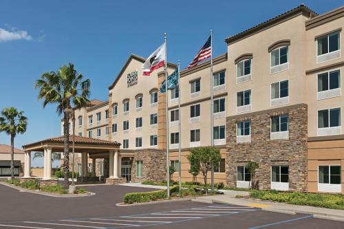 a rendering of a hotel with flags in a parking lot at Four Points by Sheraton Sacramento Airport in Sacramento