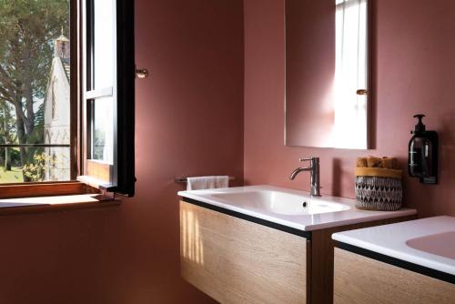 a bathroom with a sink and a window at Sella&Mosca Casa Villamarina in Alghero