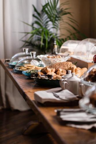 a table with food and plates of food on it at Sella&Mosca Casa Villamarina in Alghero